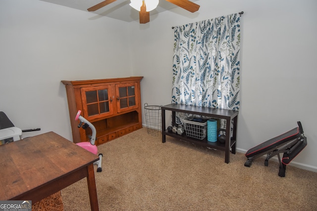 carpeted office featuring ceiling fan