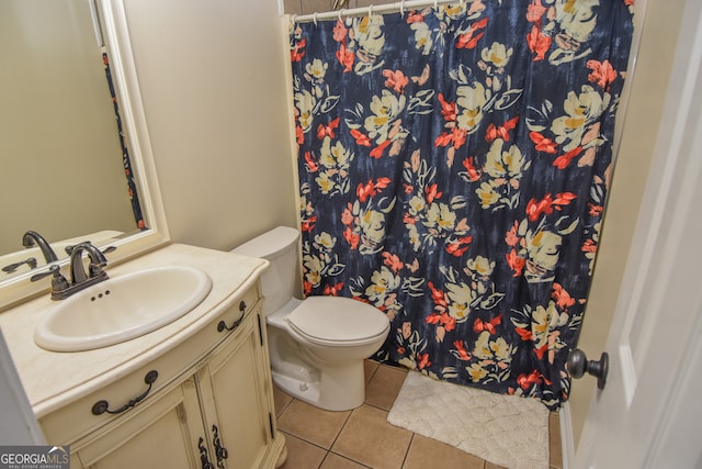 bathroom with vanity, toilet, a shower with shower curtain, and tile patterned floors