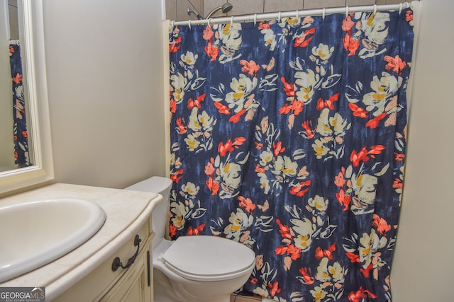 bathroom with walk in shower, vanity, and toilet