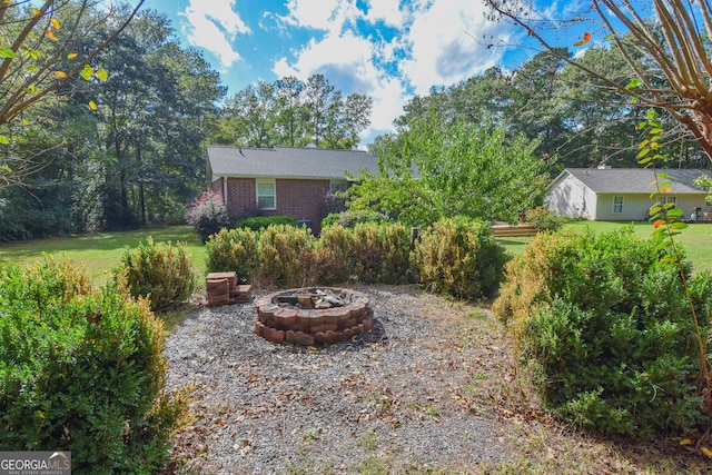 view of yard with an outdoor fire pit