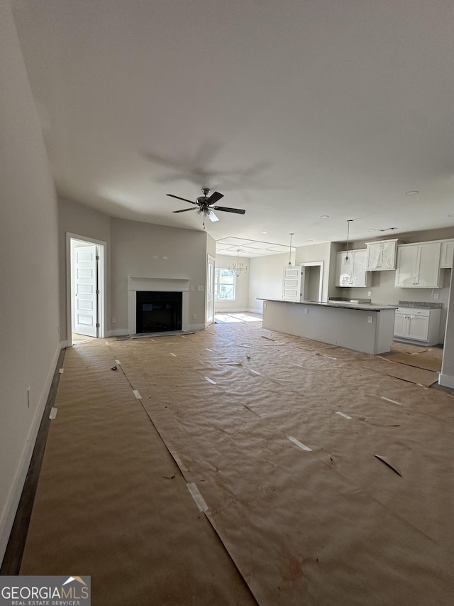 unfurnished living room featuring ceiling fan