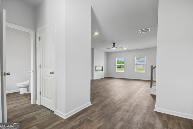 spare room featuring ceiling fan and dark wood-type flooring