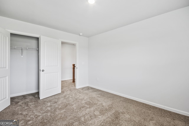 unfurnished bedroom with a closet and carpet flooring