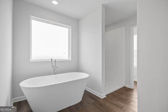 bathroom with wood-type flooring and separate shower and tub