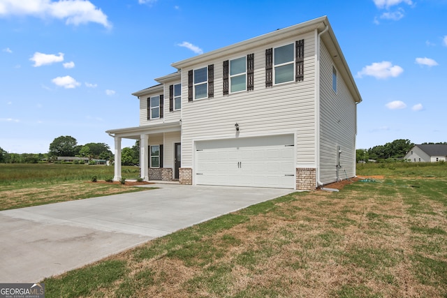 view of front facade with a front yard and a garage