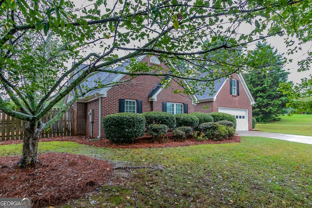 view of front facade with a garage and a front lawn