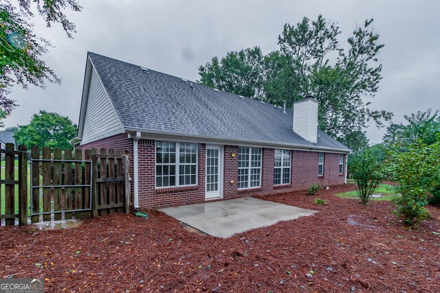 back of property featuring a patio area