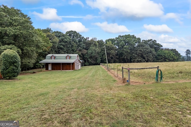 view of yard featuring an outdoor structure and a rural view