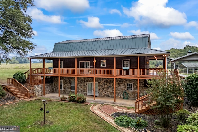 back of property featuring a lawn, a patio area, and a deck