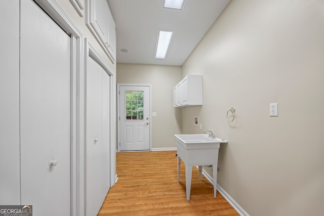 hallway with light hardwood / wood-style floors