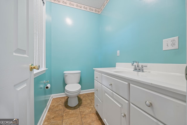 bathroom with vanity, toilet, and tile patterned floors