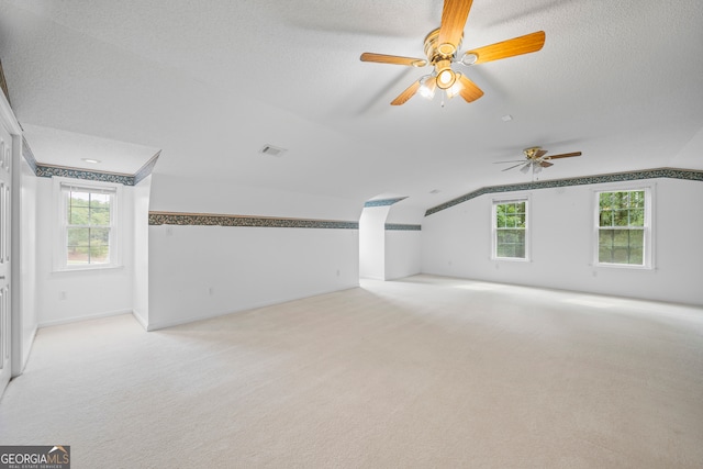 additional living space with ceiling fan, lofted ceiling, and a wealth of natural light