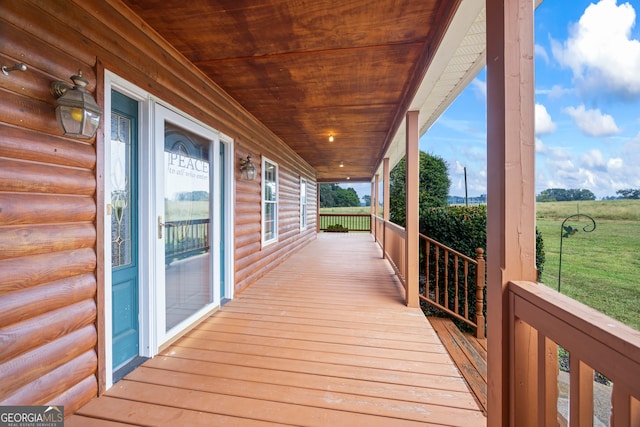 wooden terrace featuring covered porch