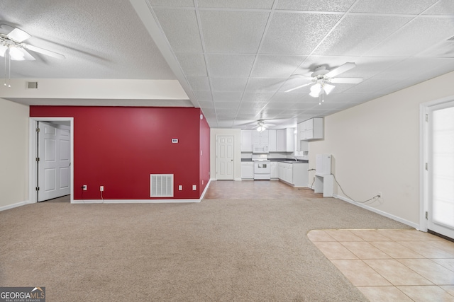 interior space featuring ceiling fan and light colored carpet