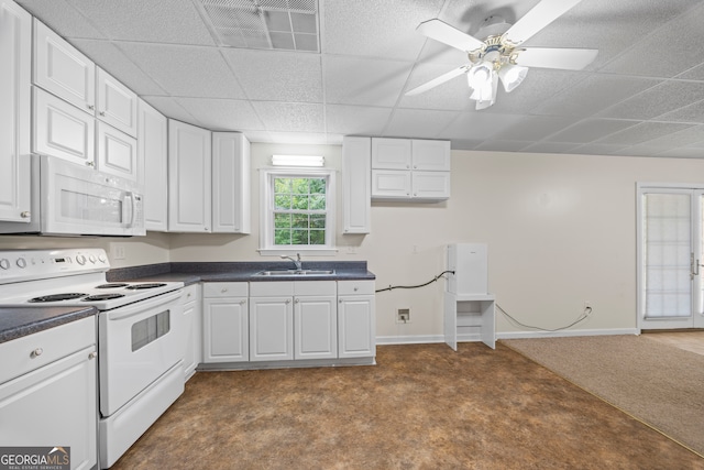 kitchen with white appliances, ceiling fan, and white cabinets