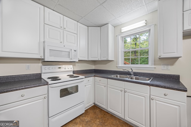 kitchen featuring a paneled ceiling, white appliances, sink, and white cabinets