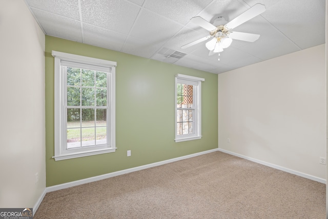 carpeted spare room with ceiling fan