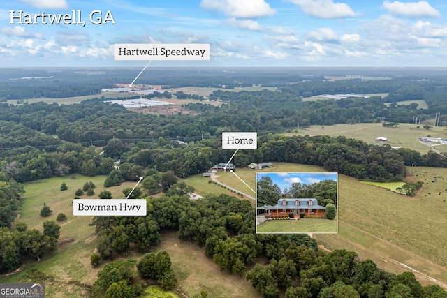 birds eye view of property with a rural view