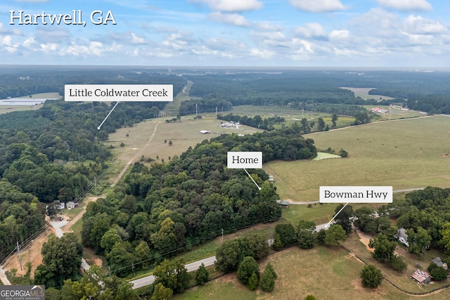 birds eye view of property with a rural view