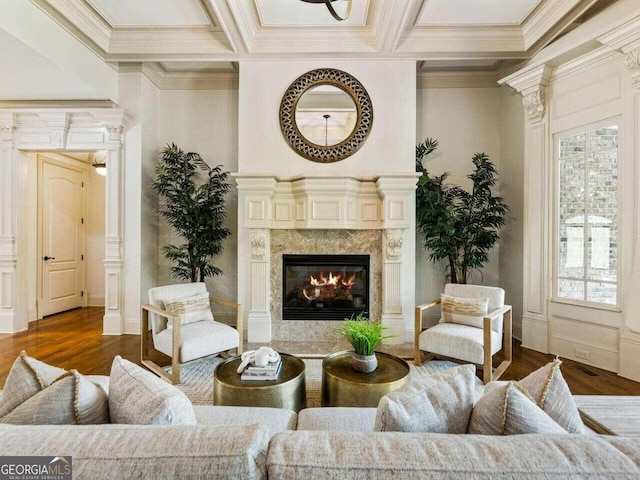 living area with ornamental molding, a fireplace, coffered ceiling, and dark wood-type flooring