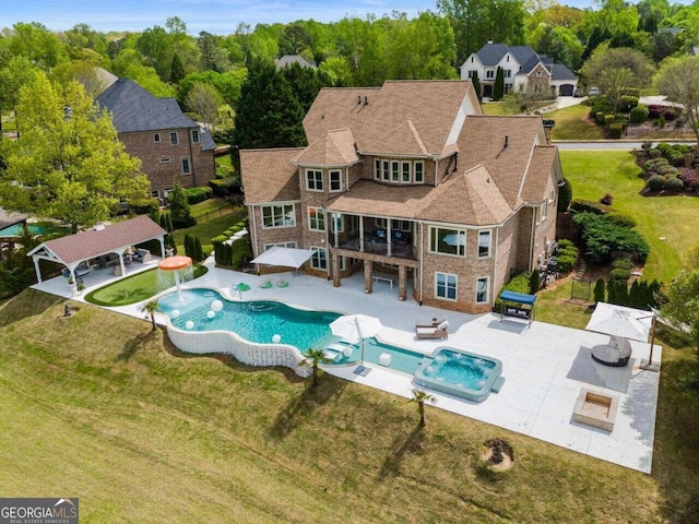 view of swimming pool with a yard, a patio area, and pool water feature