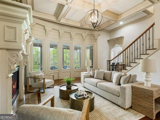 living room with coffered ceiling, beamed ceiling, and an inviting chandelier