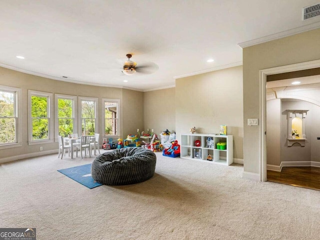 game room featuring ornamental molding, ceiling fan, and carpet