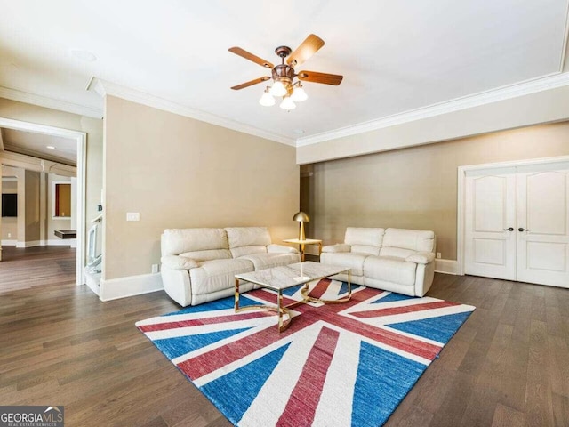 living room with ceiling fan, dark hardwood / wood-style floors, and crown molding