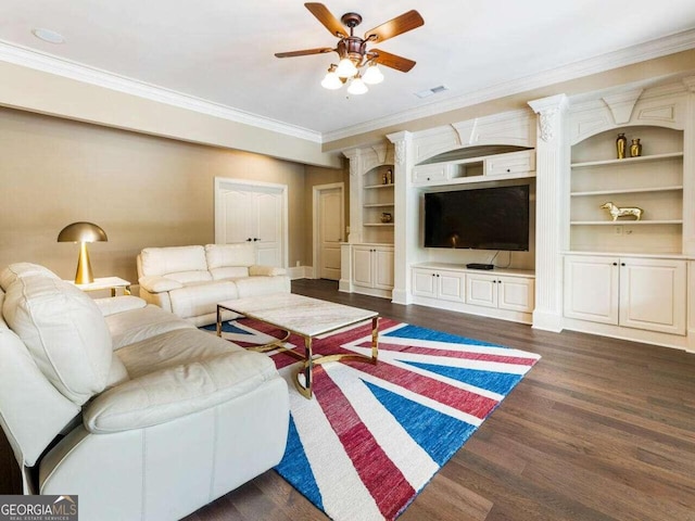 living room featuring ceiling fan, dark hardwood / wood-style flooring, ornate columns, built in features, and ornamental molding