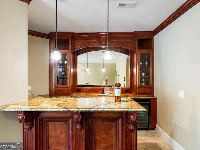 bar with hanging light fixtures, beverage cooler, and crown molding