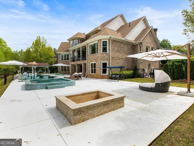 view of swimming pool with an in ground hot tub and a patio