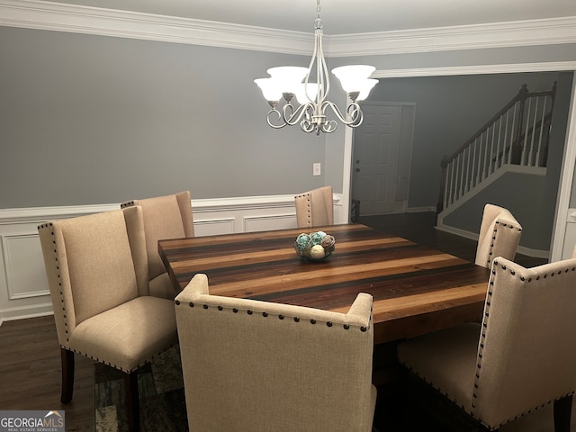 dining space featuring crown molding, an inviting chandelier, and dark wood-type flooring