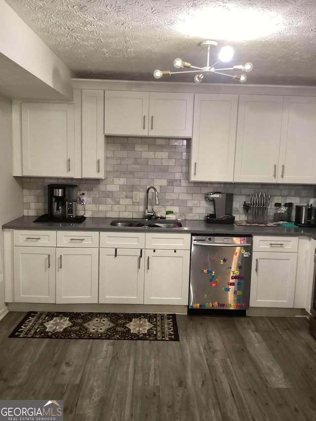 kitchen featuring decorative backsplash, white cabinets, stainless steel dishwasher, dark hardwood / wood-style floors, and sink