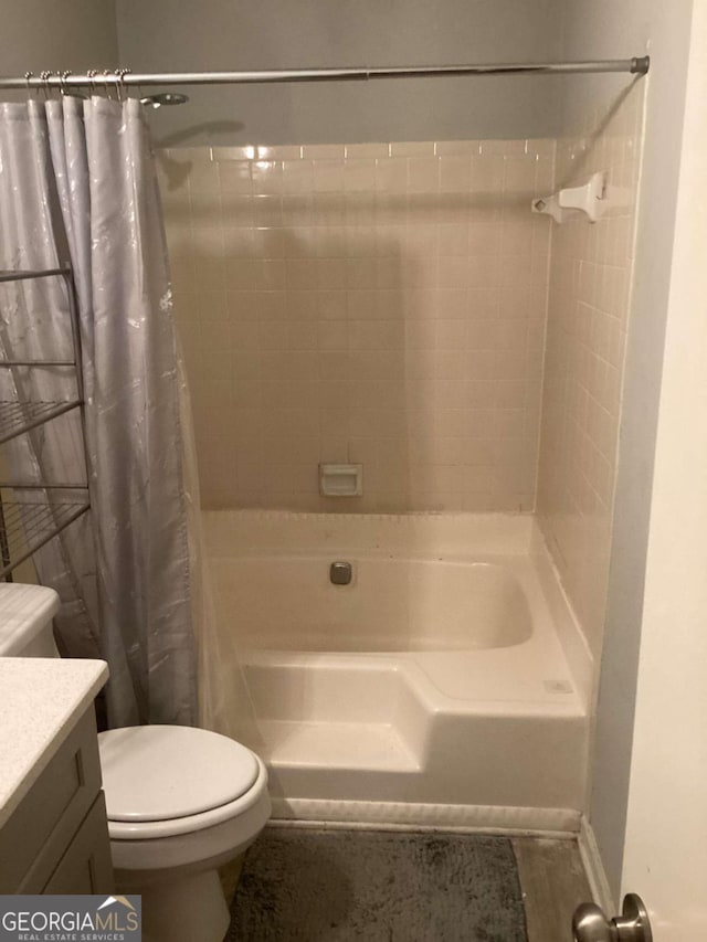 full bathroom featuring vanity, shower / tub combo, and toilet