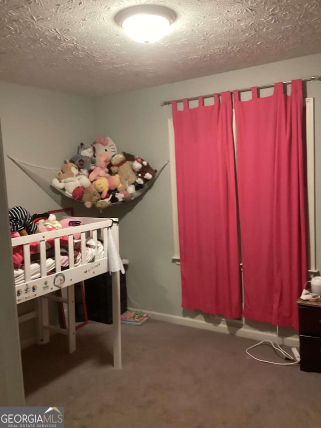 unfurnished bedroom with a textured ceiling and carpet flooring