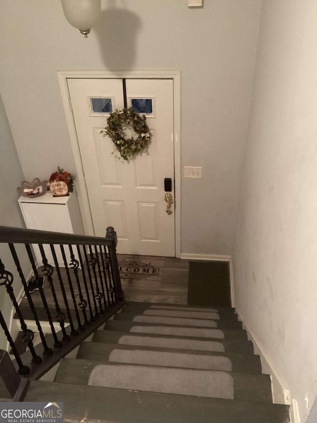 stairway with hardwood / wood-style flooring