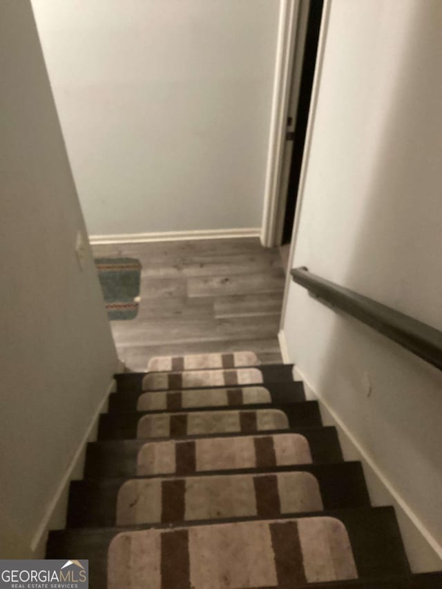 staircase featuring wood-type flooring