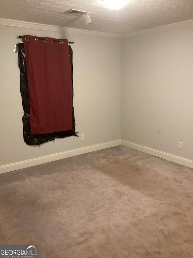 carpeted empty room featuring a textured ceiling and ornamental molding