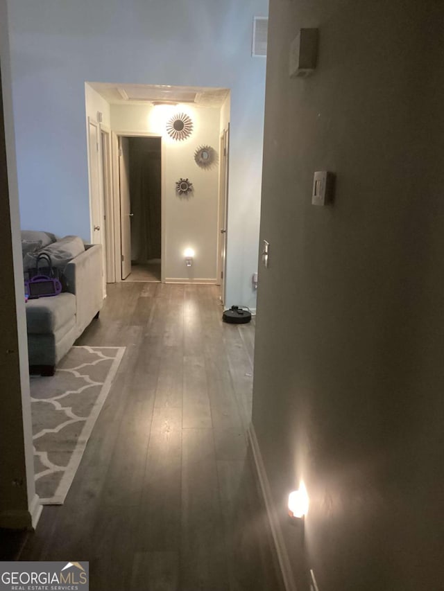 hallway with hardwood / wood-style flooring