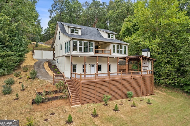 back of property with a gazebo, a garage, and a deck