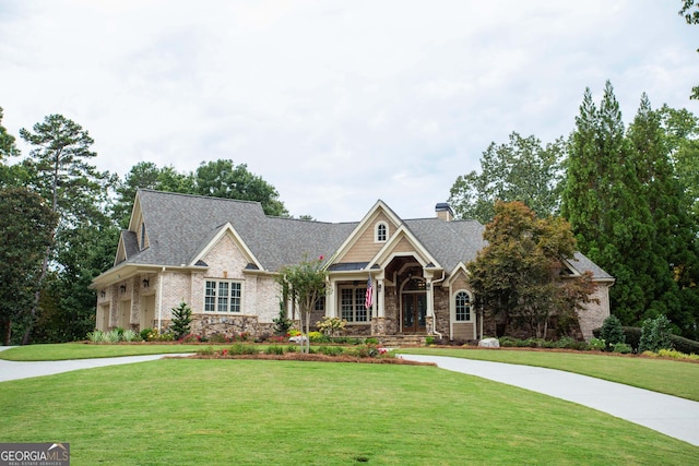 craftsman house featuring a front yard and a garage