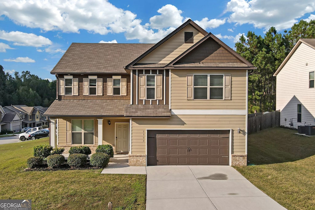 view of front of house featuring a front yard, cooling unit, and a garage