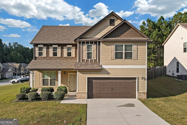 view of front of house featuring a front yard, cooling unit, and a garage