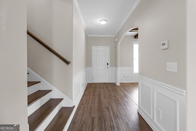 entrance foyer featuring crown molding and dark hardwood / wood-style floors