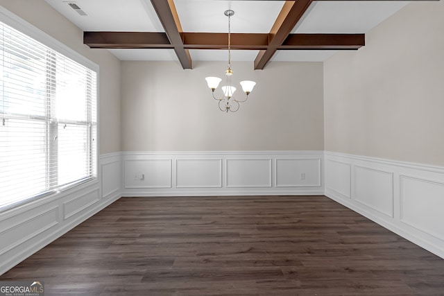 unfurnished dining area featuring an inviting chandelier, a wealth of natural light, beam ceiling, and dark hardwood / wood-style flooring