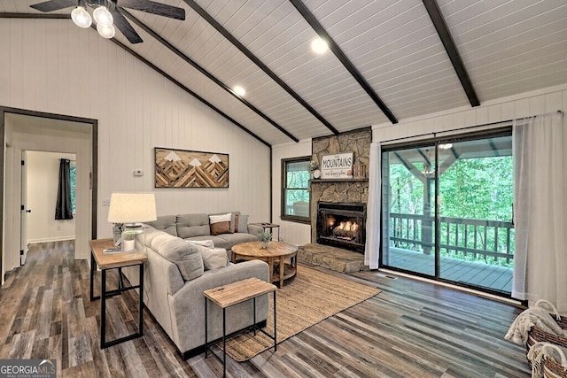 living room featuring beamed ceiling, high vaulted ceiling, a stone fireplace, dark hardwood / wood-style floors, and wooden ceiling