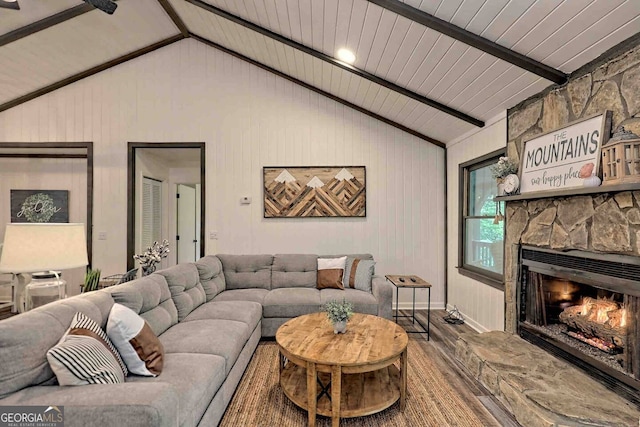 living room featuring a fireplace, vaulted ceiling with beams, wood ceiling, and wood-type flooring