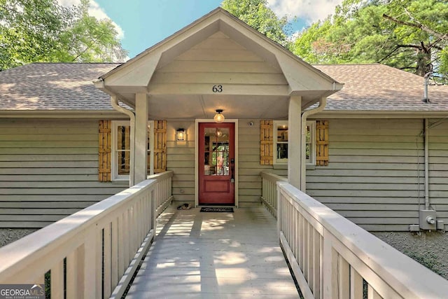 view of exterior entry with a porch