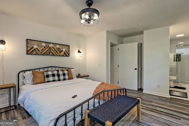 bedroom featuring a closet, dark hardwood / wood-style floors, and connected bathroom