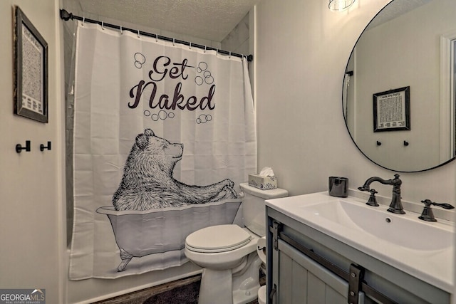 bathroom with a shower with curtain, vanity, toilet, and a textured ceiling